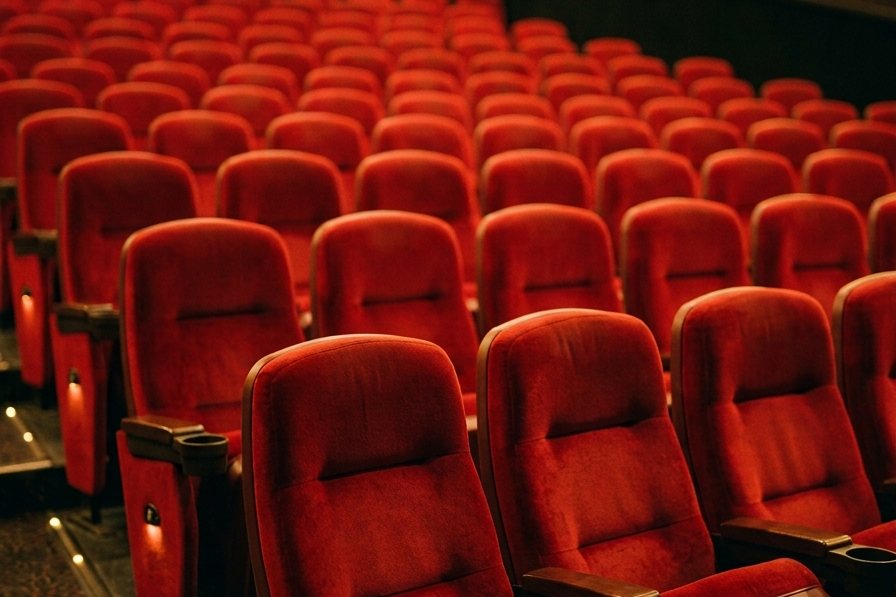 Rows of red cinema seats with cupholders